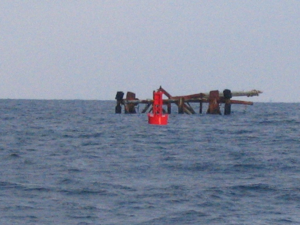 Red BL 620 steel buoy on station marking an offshore platform jacket