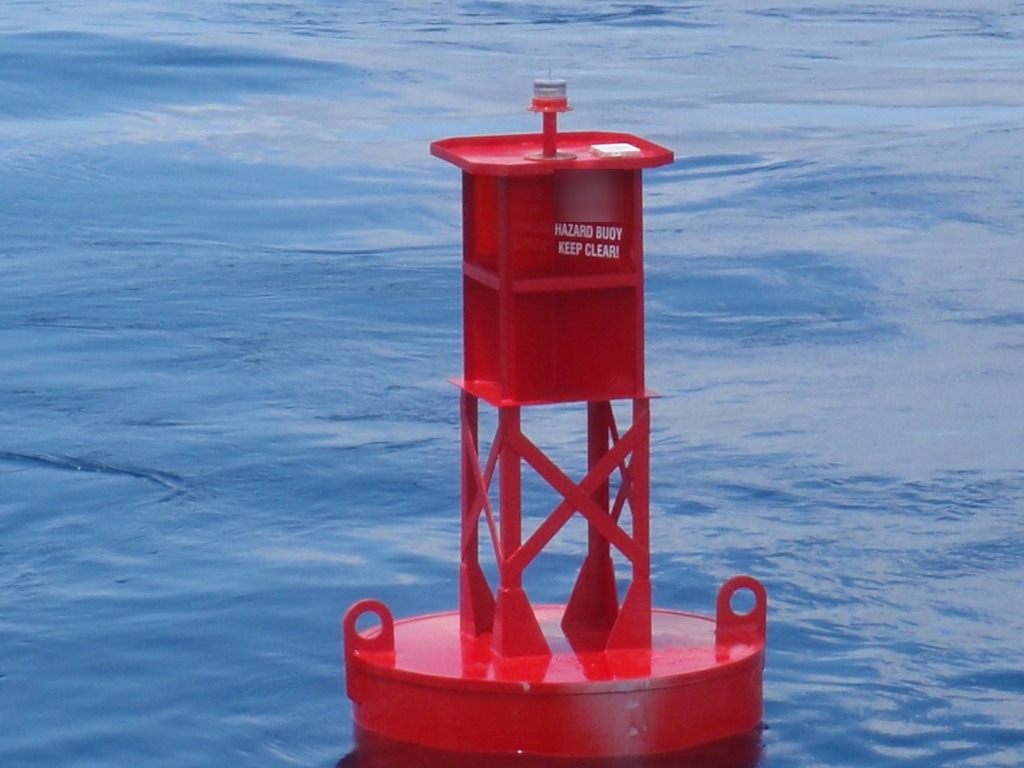 Red BL 620 6 x 20 steel buoy with LED lantern, welded tower and built-in radar reflector on station offshore