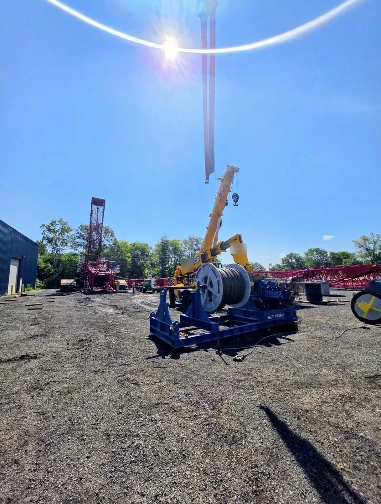 Wet Tech RS-001 spooling unit with a reel of wire rope in a crane yard